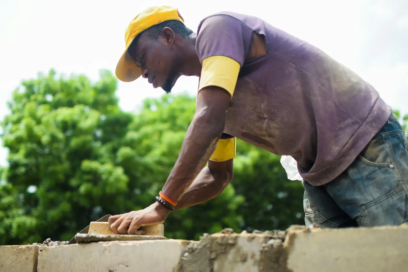 Bricklayer laying a course of bricks